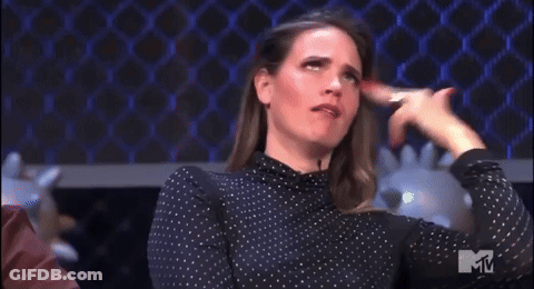 A Woman In A Polka Dot Shirt Is Making A Funny Face With The Letter M In The Corner GIF