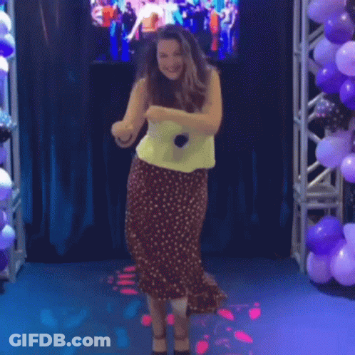 Woman In Polka Dot Skirt Dancing With Microphone GIF
