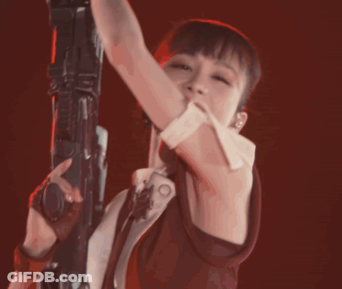 A Woman In A Ponytail Is Holding A Rifle GIF