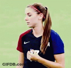 A Woman In A Ponytail Is Wearing A Nike Shirt And A Headband . GIF