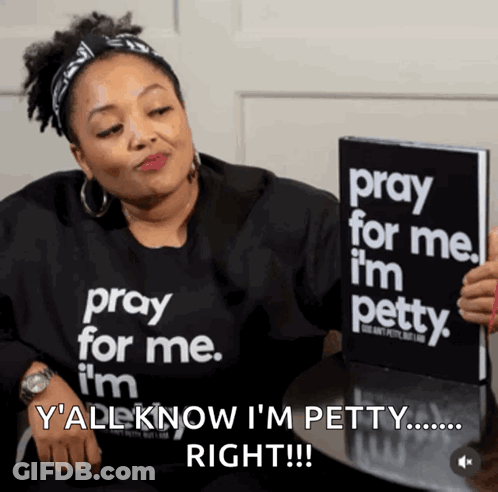 A Woman In A Pray For Me I 'M Petty Shirt Holds A Book GIF