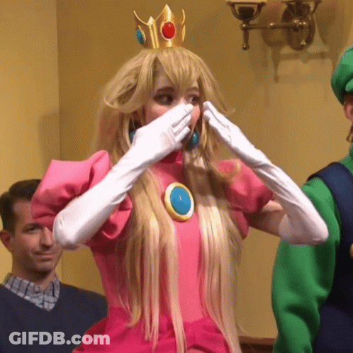 A Woman In A Princess Peach Costume Is Covering Her Mouth GIF