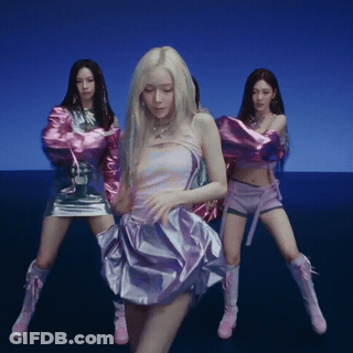 A Woman In A Purple Dress Is Dancing With Two Other Girls GIF