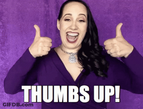 A Woman In A Purple Dress Is Giving Two Thumbs Up And The Caption Says Thumbs Up ! GIF