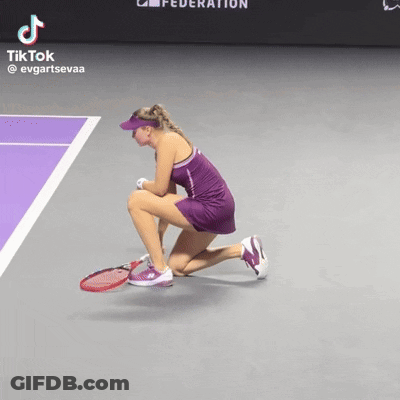A Woman In A Purple Dress Is Kneeling Down On A Tennis Court With A Tiktok Watermark GIF