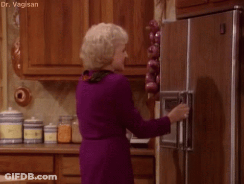 A Woman In A Purple Dress Is Opening The Door Of A Refrigerator . GIF