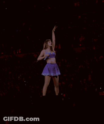 Woman In Purple Dress Singing Into Microphone GIF