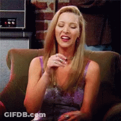 A Woman In A Purple Dress Is Sitting In A Chair With Her Eyes Closed And Smiling . GIF