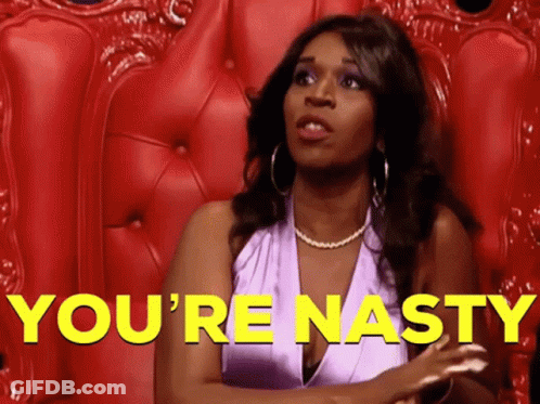 A Woman In A Purple Dress Is Sitting In A Red Chair With The Words You 'Re Nasty In Yellow Letters Behind Her GIF