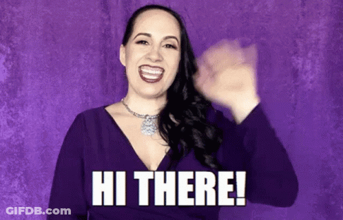 A Woman In A Purple Dress Is Smiling And Waving Her Hand With The Words Hi There . GIF