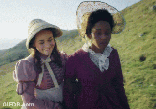 A Woman In A Purple Dress Is Walking With Another Woman GIF