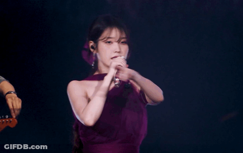 A Woman In A Purple Dress Singing Into A Microphone With The Words Slayed It In Blue GIF