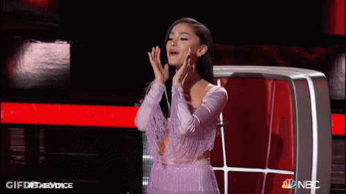 Woman In Purple Dress In Front Of NBC Screen GIF