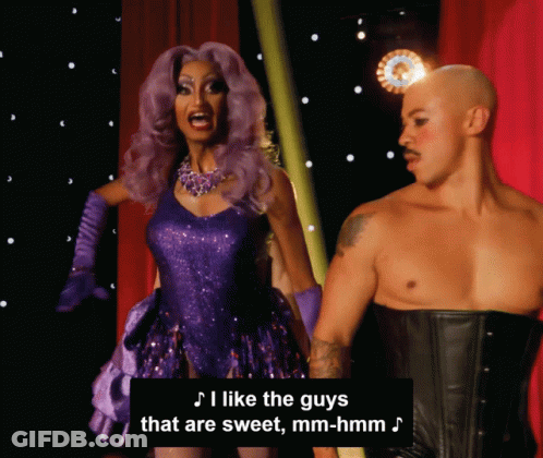 Woman In Purple Dress Next To Man In Black Corset GIF