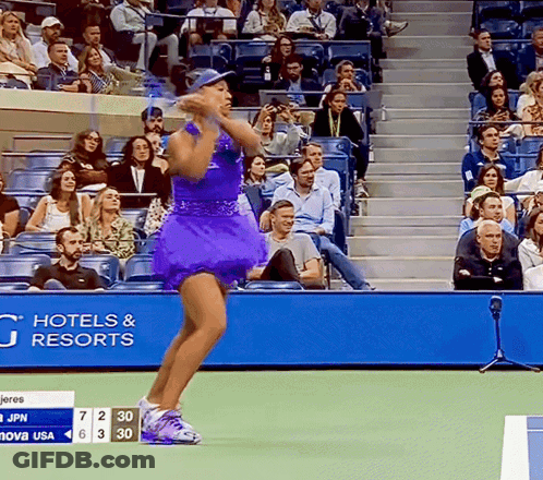 A Woman In A Purple Dress Stands On A Tennis Court In Front Of A Hotel And Resorts Banner GIF