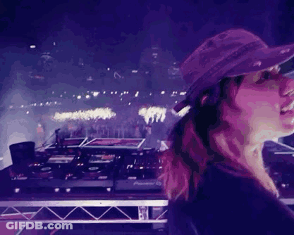 A Woman In A Purple Hat Is Standing In Front Of A Pioneer Dj Controller GIF