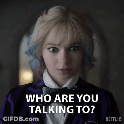 A Woman In A Purple Jacket And Bow Tie Is Asking Who Are You Talking To GIF