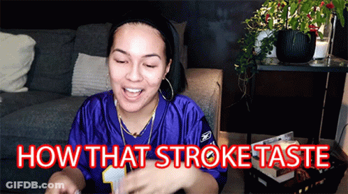 A Woman In A Purple Jersey Is Sitting On A Couch And Says How That Stroke Taste GIF