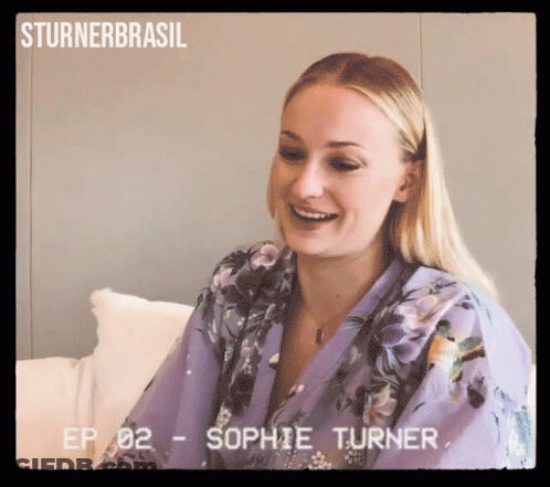 A Woman In A Purple Robe Is Smiling And Ep 02 - Sophie Turner GIF