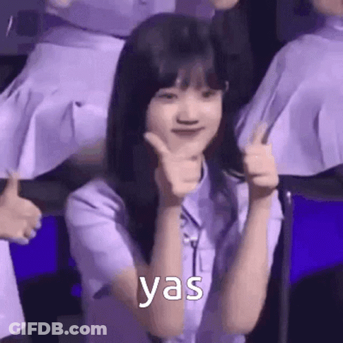A Woman In A Purple Shirt Is Giving A Thumbs Up Sign . GIF