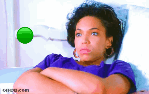 A Woman In A Purple Shirt Is Laying In A Hospital Bed GIF