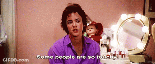 A Woman In A Purple Shirt Is Saying Some People Are So Touchy . GIF