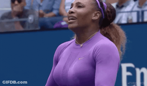 A Woman In A Purple Shirt Is Standing On A Tennis Court With Her Eyes Closed . GIF