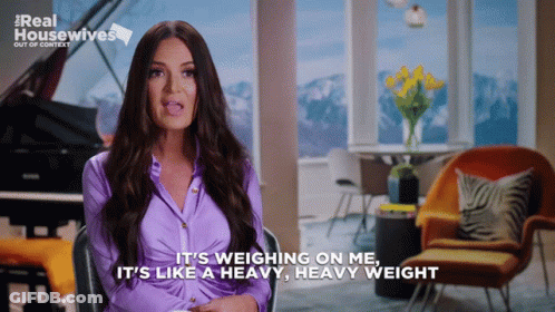 A Woman In A Purple Shirt Says It 'S Weighing On Me And It 'S Like A Heavy Heavy Weight GIF