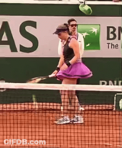 A Woman In A Purple Skirt Is Holding A Tennis Racquet On A Tennis Court In Front Of A Bnl Sign GIF