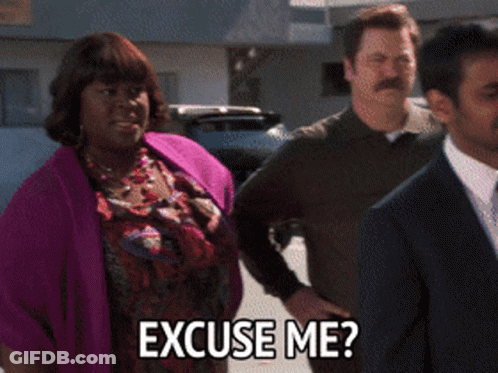 A Woman In A Purple Sweater Is Asking Someone To Excuse Her GIF