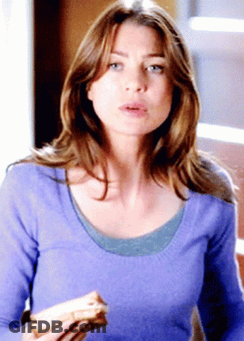 A Woman In A Purple Sweater Is Holding A Sandwich In Her Hand GIF