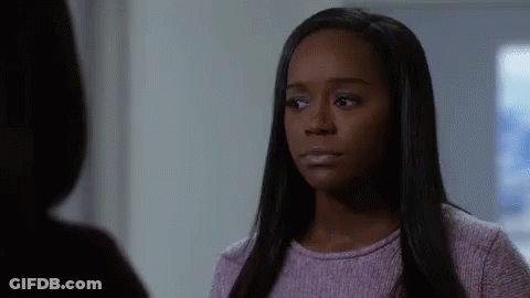 A Woman In A Purple Sweater Is Talking To Another Woman In A Room . GIF