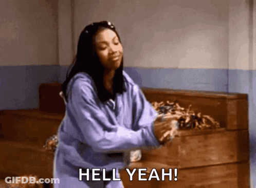 A Woman In A Purple Sweatshirt Is Dancing And Saying Hell Yeah ! GIF