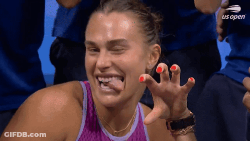 A Woman In A Purple Tank Top Is Making A Funny Face At The Us Open Tennis Tournament GIF