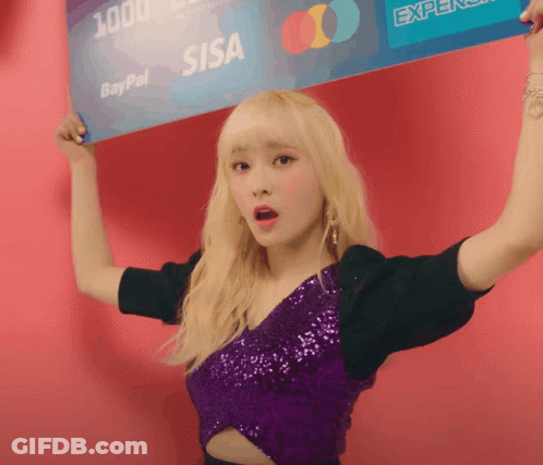 A Woman In A Purple Top Holds Up A Paypal Card Over Her Head GIF