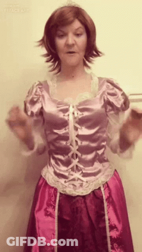 A Woman In A Rapunzel Costume Has Her Hands Outstretched GIF