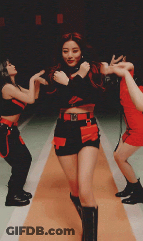 A Woman In A Red And Black Outfit Is Dancing GIF