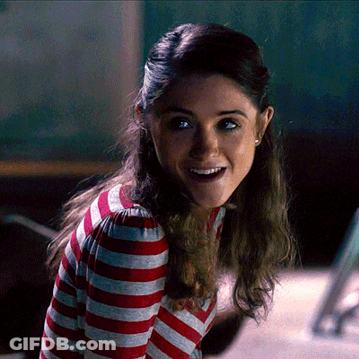 A Woman In A Red And White Striped Shirt Is Smiling GIF