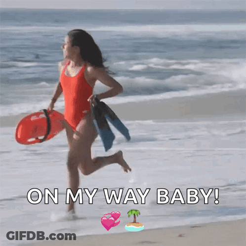 A Woman In A Red Bathing Suit Is Running On The Beach With The Words On My Way Baby Below Her GIF