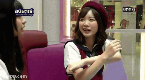 A Woman In A Red Beret Is Talking To Another Woman GIF
