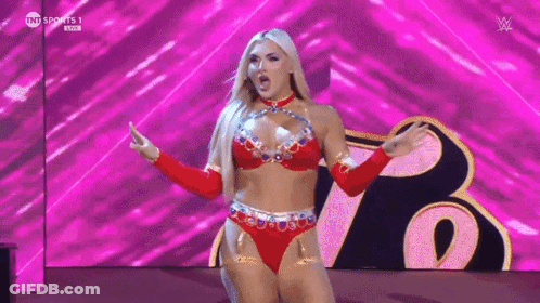 A Woman In A Red Bikini Is Standing On A Stage With Her Arms Outstretched . GIF