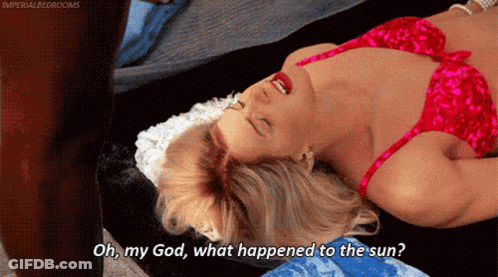 A Woman In A Red Bra Is Laying On A Bed With Her Mouth Open And Says Oh My God What Happened To The Sun GIF