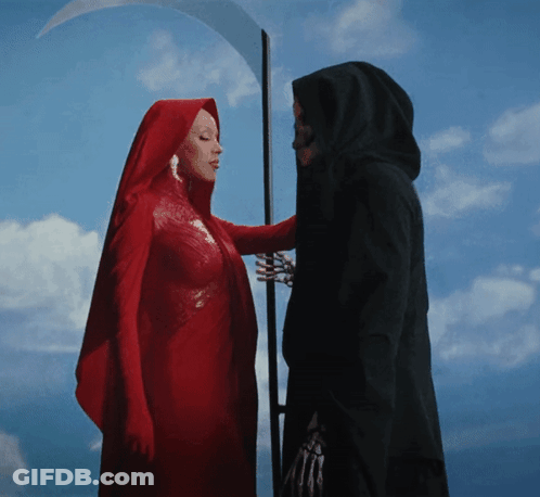 A Woman In A Red Cape Stands Next To A Grim Reaper With A Scythe GIF