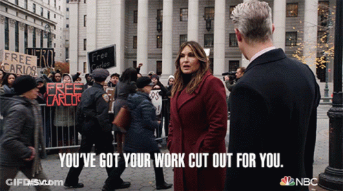 A Woman In A Red Coat Stands Next To A Man In A Black Suit And Says You 'Ve Got Your Work Cut Out GIF
