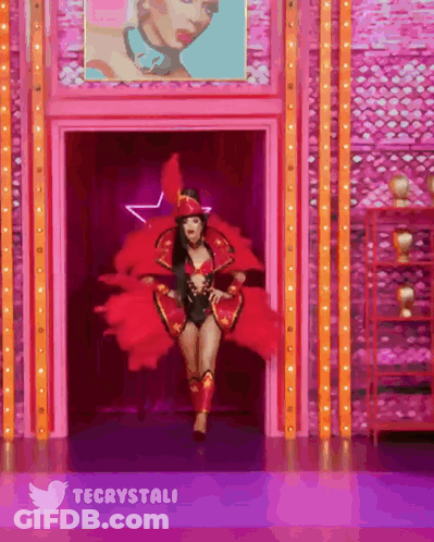 Woman In Red Costume Walking Through Doorway With Twitter Logo GIF