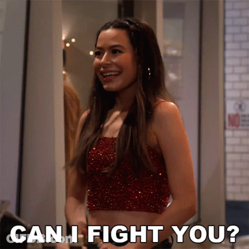 A Woman In A Red Crop Top Is Smiling And Asking " Can I Fight You " GIF