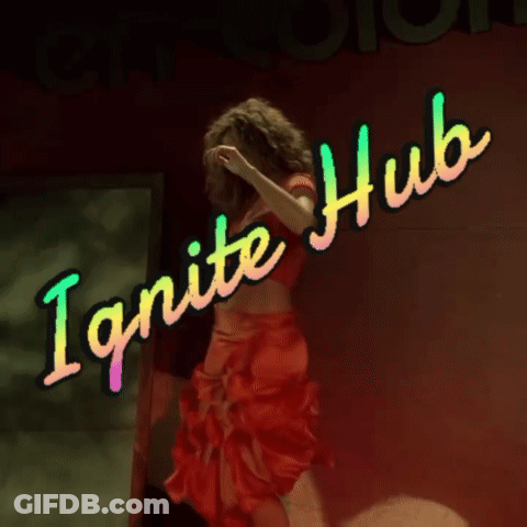 A Woman In A Red Crop Top Is Standing In Front Of A Neon Sign That Says Ignite Hub GIF