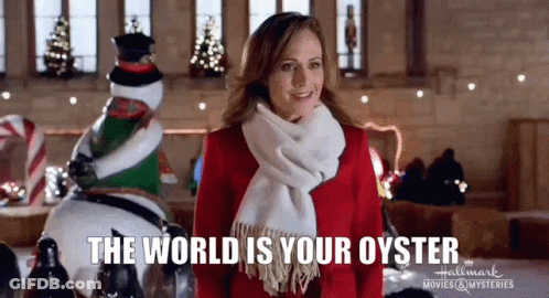 A Woman In A Red Dress And Scarf Is Standing In Front Of A Christmas Decoration And A Snowman . GIF