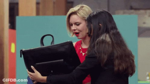 A Woman In A Red Dress Holds A Black Purse With The Letter O On It GIF