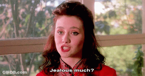 A Woman In A Red Dress Is Asking If She Is Jealous GIF